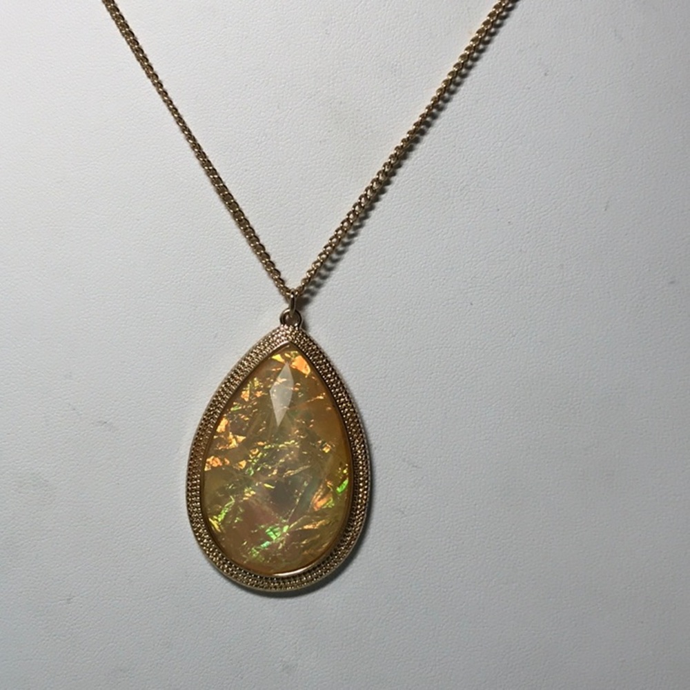 NRQ teardrop necklace, pendant is a gold tone color, no tarnish